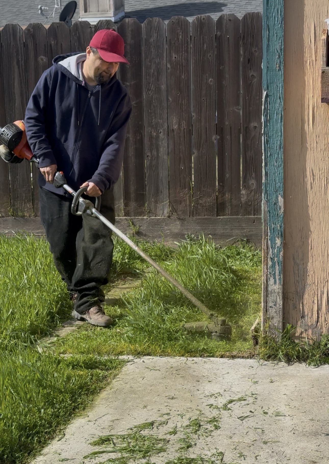 VerdePath specialist weed-eating along fence